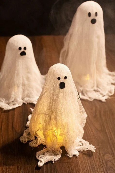 Cute ghost decor idea 3: Craft Cheesecloth Ghosts That Glow From Within