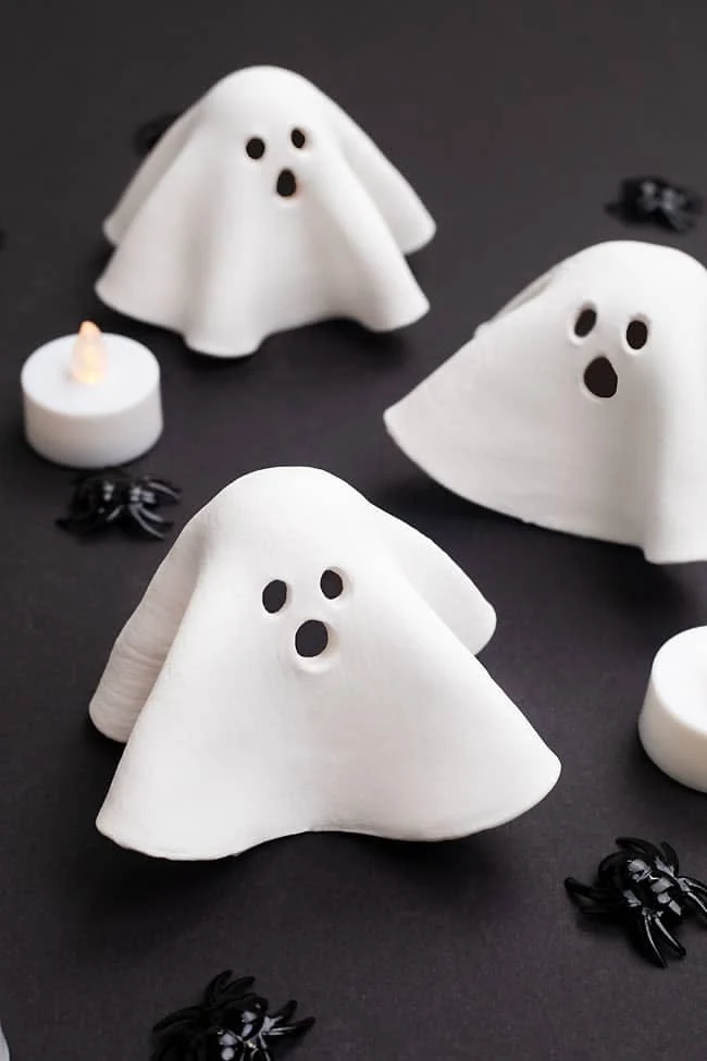 Cute ghost decor idea 7: Gather Clay Ghosts Around One Candle