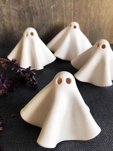 Cute ghost decor idea 8: Group Five Tiny Clay Ghosts on Dark Fabric