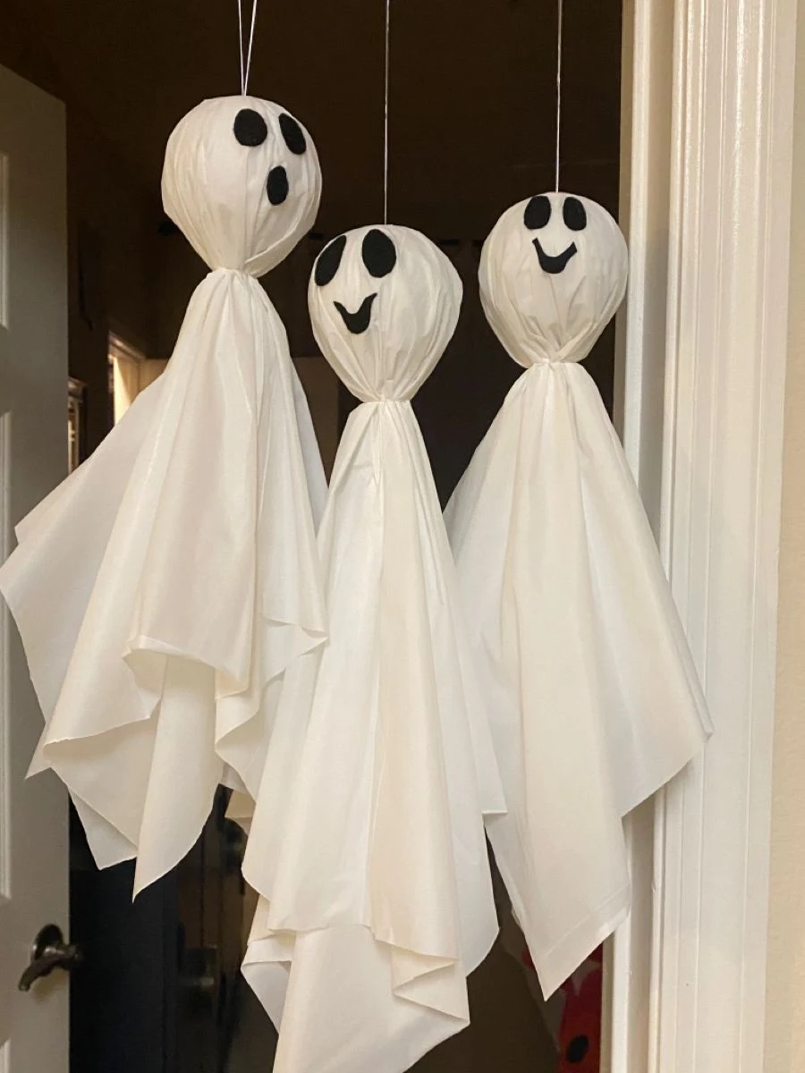 Cute ghost decor idea 14: Hang Smiling Sheet Ghosts in a Bright Doorway