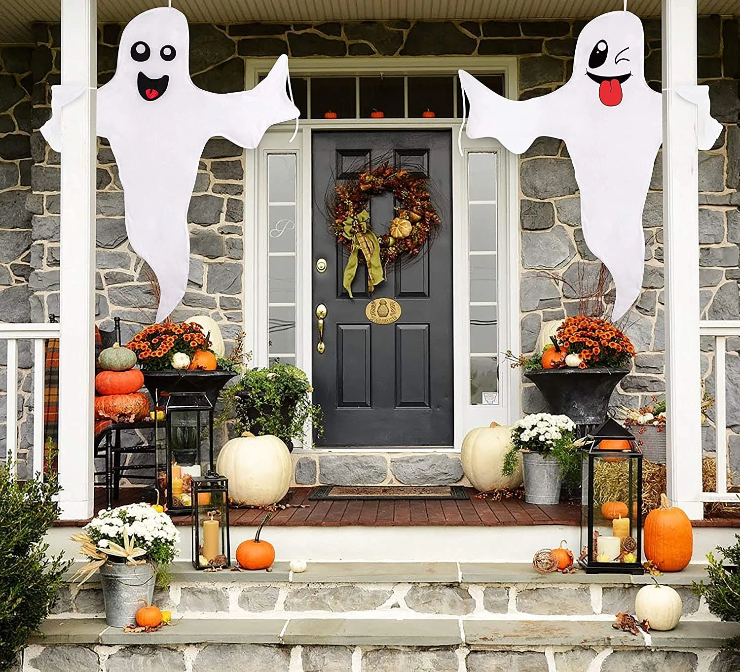 Cute ghost decor idea 24: Flank the Front Door With Giant Ghost Cutouts