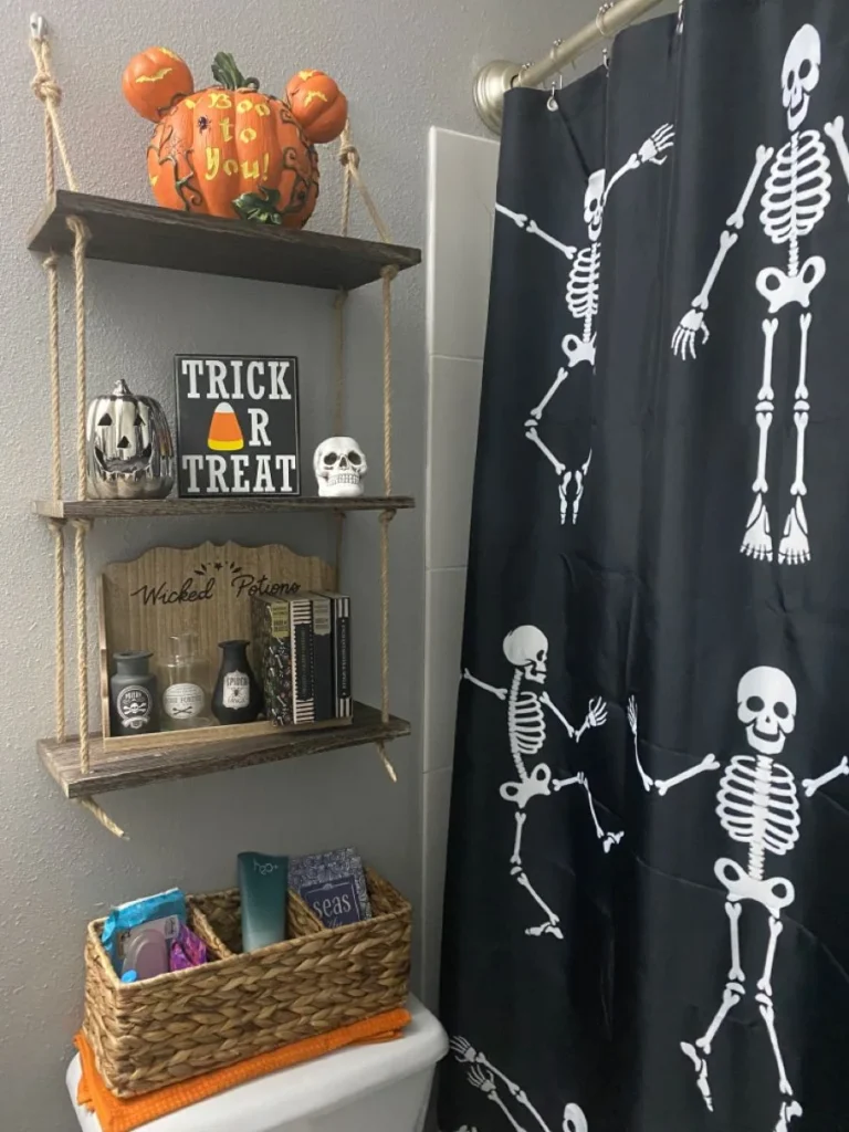 Halloween bathroom decorating idea 6: Hang a Dancing Skeleton Shower Curtain Beside Open Shelves