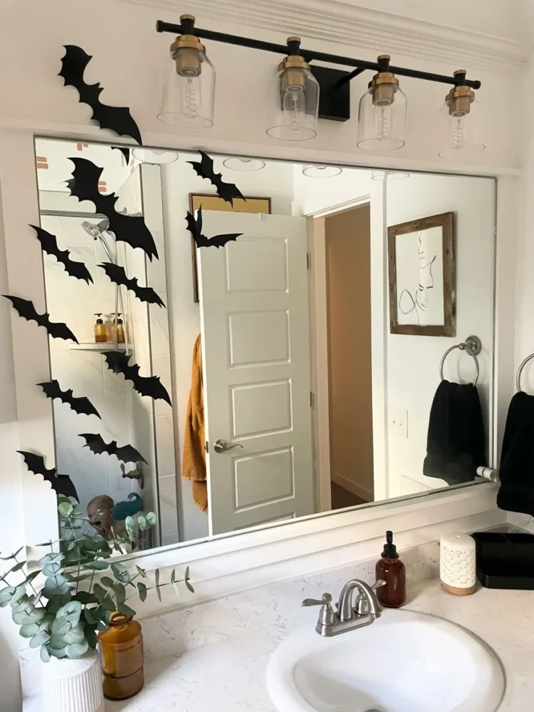 Halloween bathroom decorating idea 11: Keep It Light With One Trail of Bats up the Mirror
