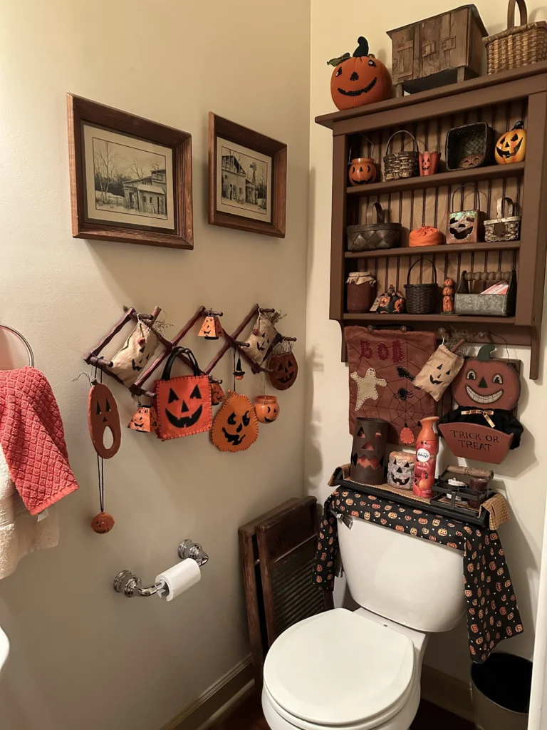 Halloween bathroom decorating idea 15: Fill a Tall Shelf Over the Toilet With Tiny Halloween Pieces