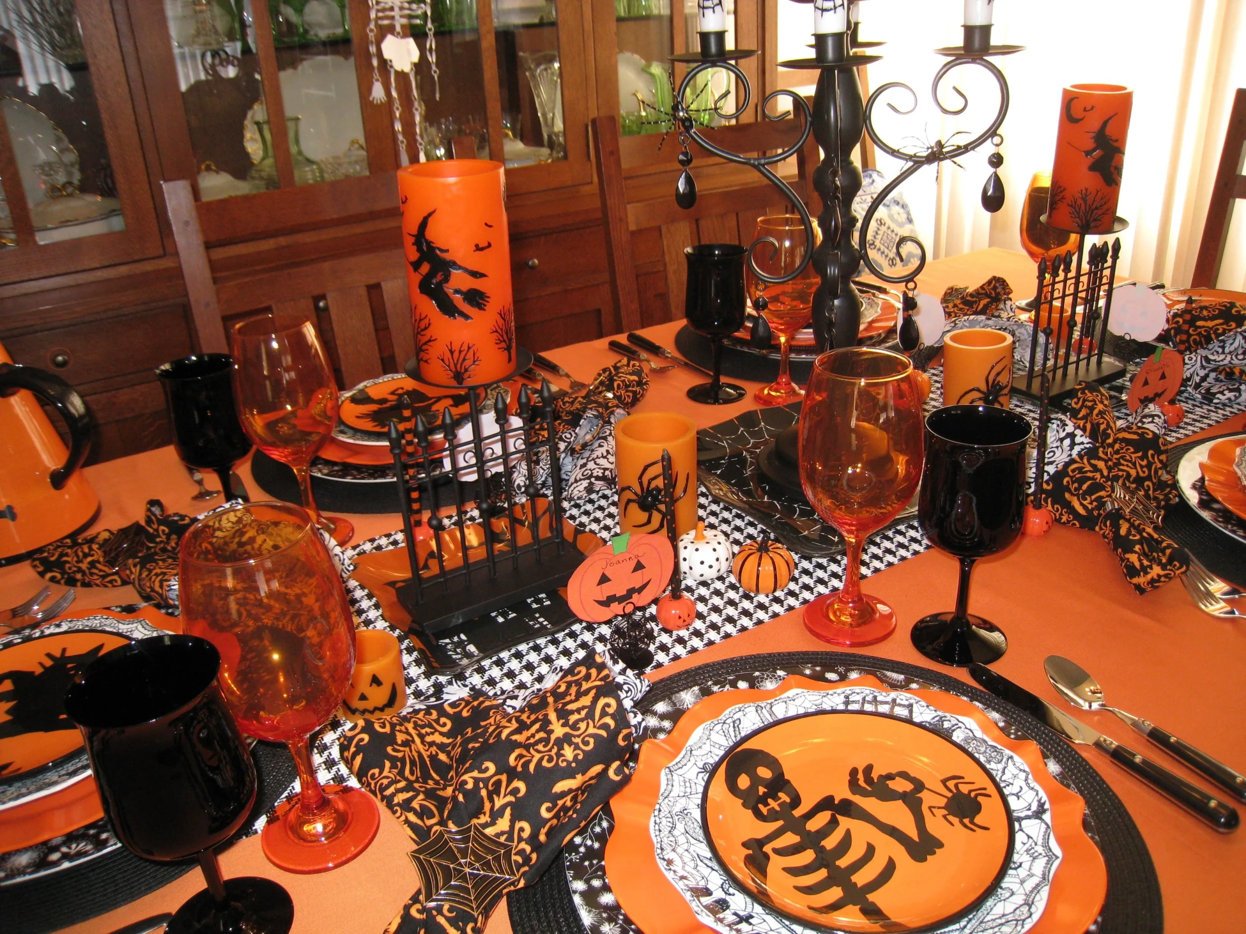 Halloween tablescape idea 1: Set a Playful Orange-and-Black Table With Pumpkin Plates