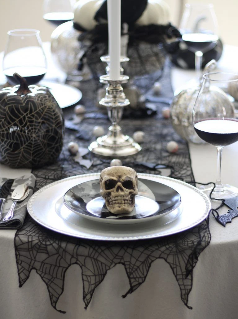 Halloween tablescape idea 2: Crown Each Place Setting With a Small Skull
