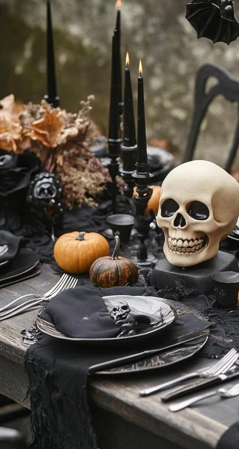 Halloween tablescape idea 4: Layer Black Candles and Mini Pumpkins at Each Setting