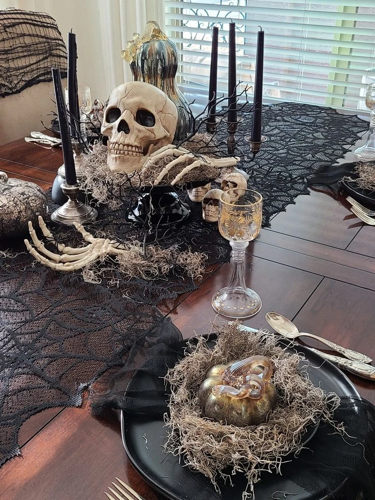 Halloween tablescape idea 10: Drape Black Gauze and Cloche Pumpkins Down the Middle