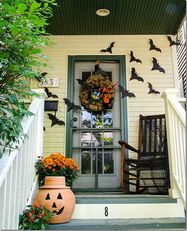 Vintage Halloween decor idea 21: Hang Paper Bats Flying Up the Porch Wall